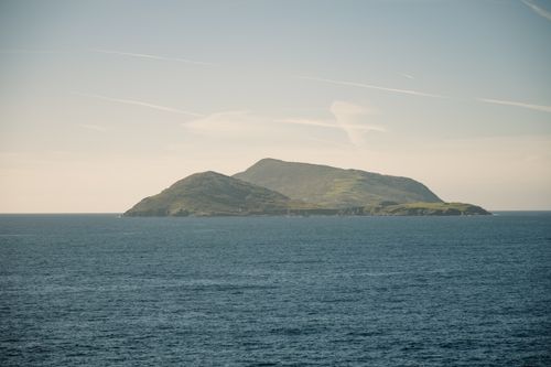 Free A calm and serene view of the Blasket Islands in Ireland surrounded by ocean under a clear sky. Stock Photo