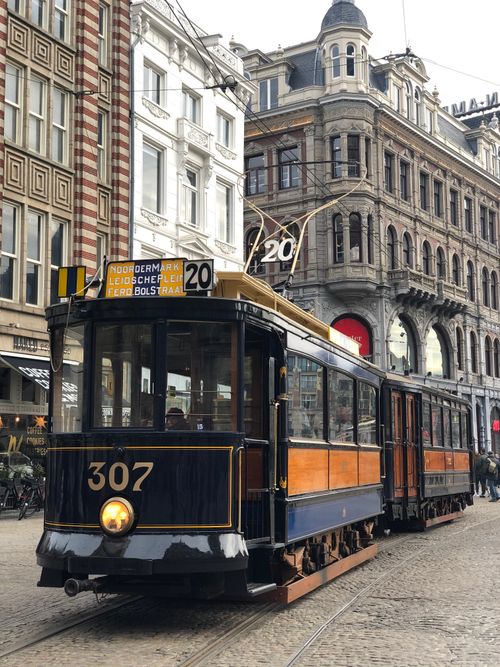 Free Vintage tram 307 travels through the historic streets of Amsterdam, showcasing classic architecture. Stock Photo