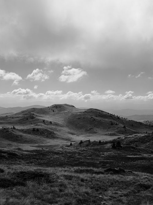 Free Dramatic monochrome landscape of rolling hills and cloudy skies in Bosnia. Stock Photo