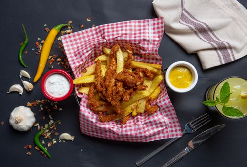 Free Overhead shot of crispy chicken strips with fries, side sauces, and lemonade. Stock Photo