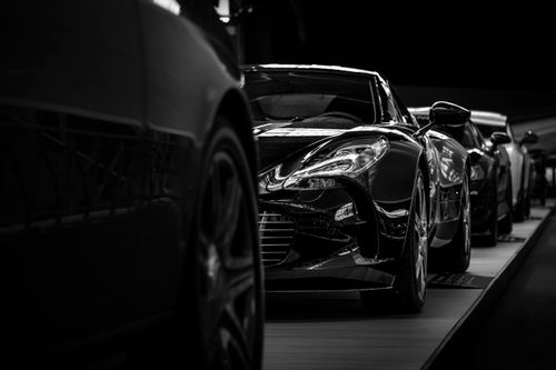 Free Black and white photo of sleek luxury sports cars lined up showcasing elegance and design. Stock Photo