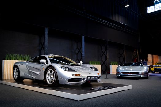 A sleek and sophisticated showcase of high-end sports cars in an indoor showroom setting.