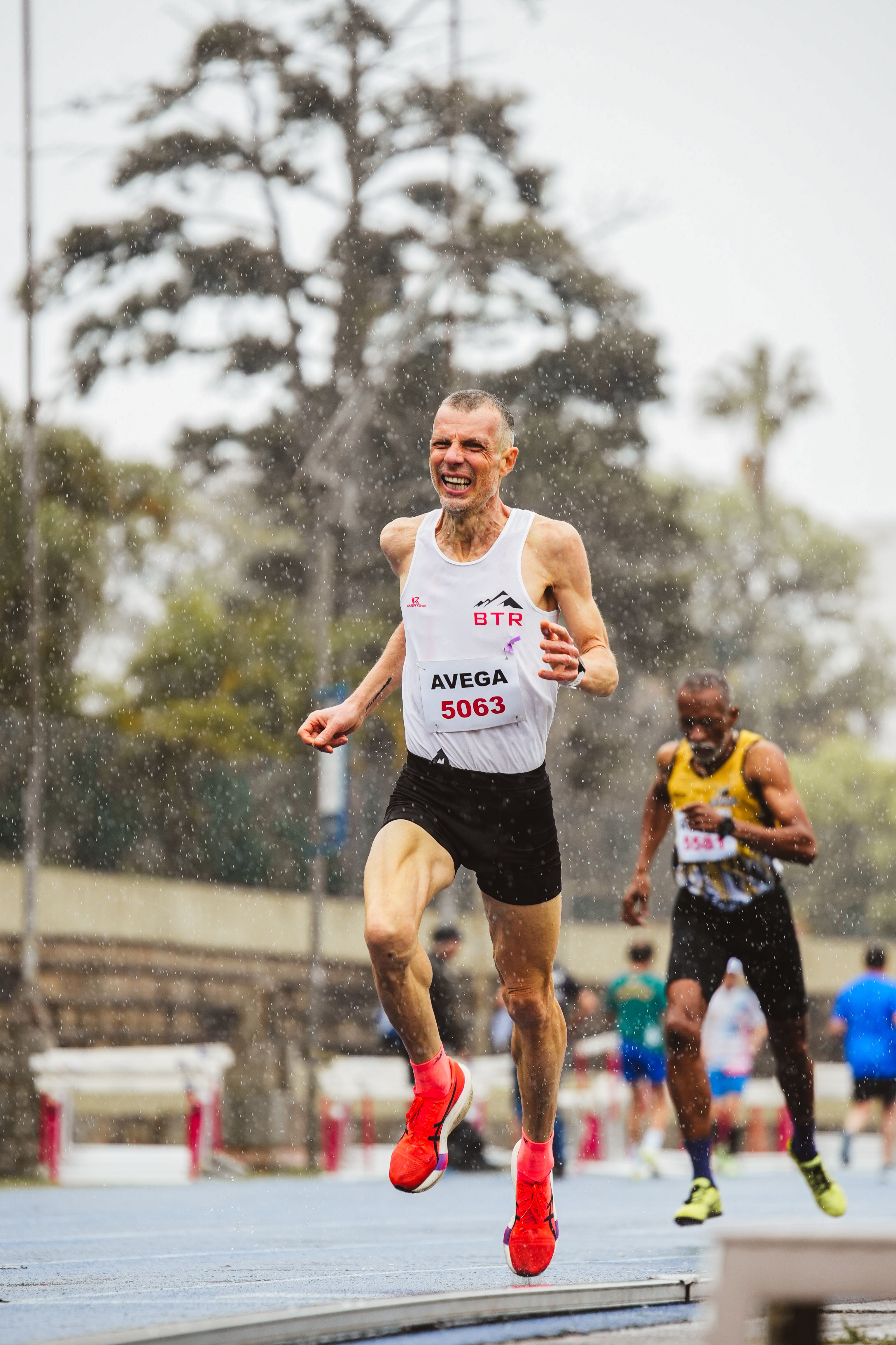 Energetic Runners Competing in Track Event · Free Stock Photo