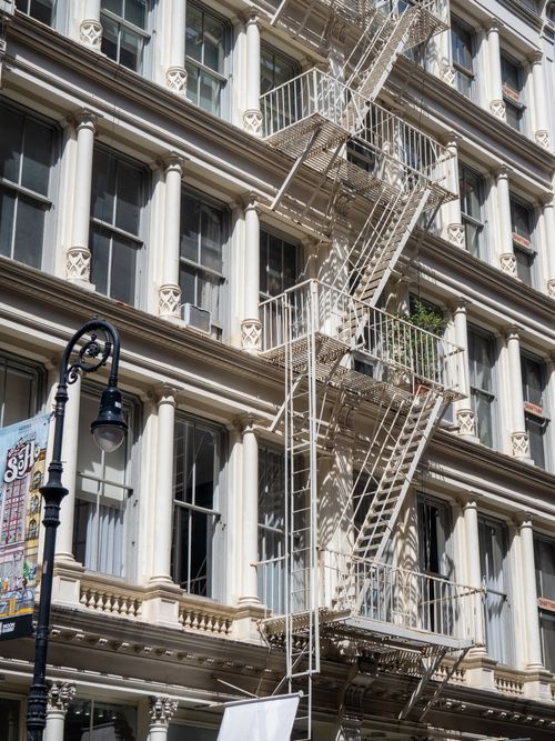 Free Classic cast iron architecture in NYC with vintage fire escape. Stock Photo