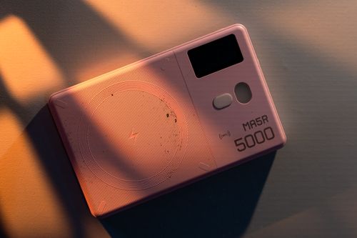 Free A sleek pink electronic device in soft sunset lighting, showcasing futuristic design and functionality. Stock Photo