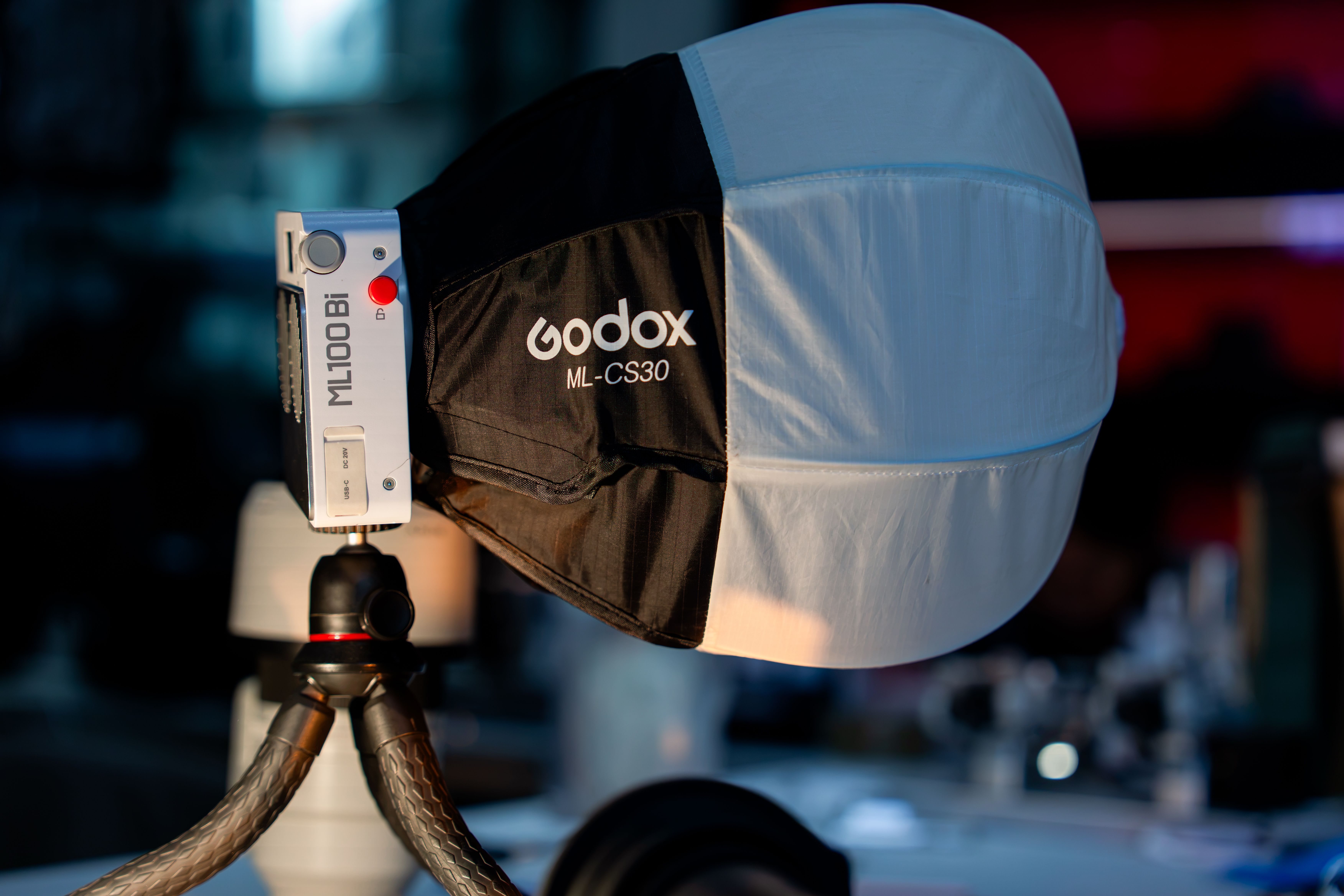 Close-up of a Godox ML100Bi light with softbox in a photography studio.
