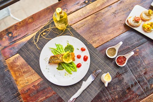 Grilled fish steaks served with vegetables and sauces