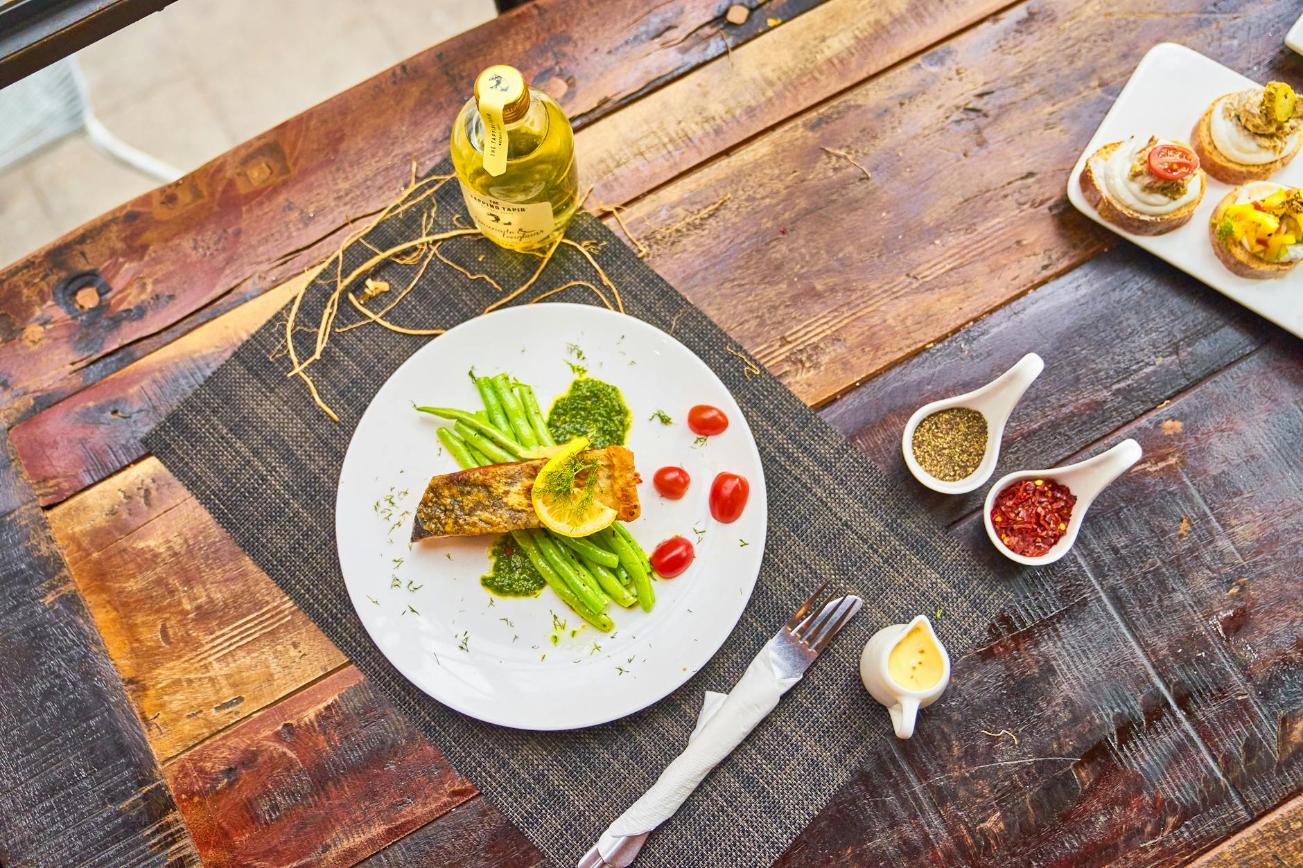 Grilled fish steaks served with vegetables and sauces