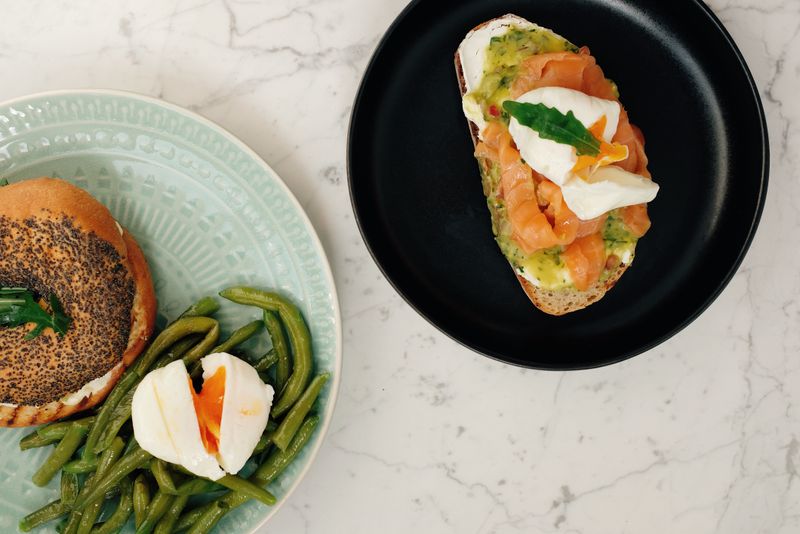 avocado toast topped with a soft boiled egg