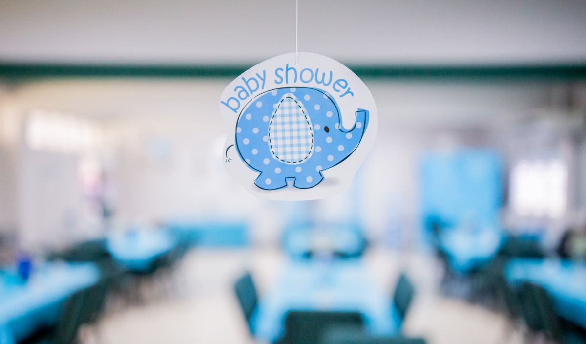 A cute blue elephant decoration hanging at a baby shower event with a blurred background. Stock Photo.