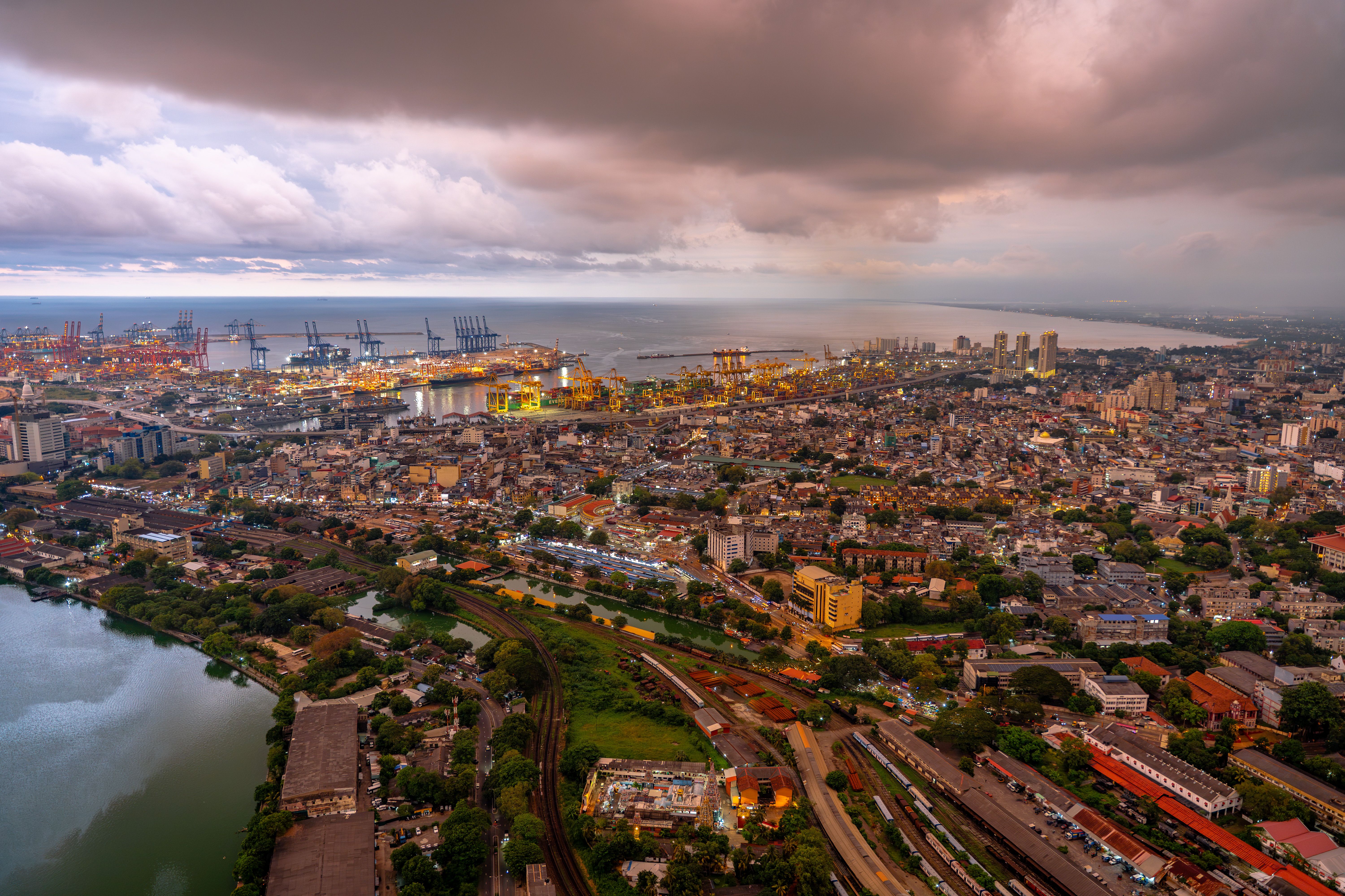 Stunning aerial view of Colombo city skyline and port during twilight, showcasing urban landscape. — arriving in Colombo