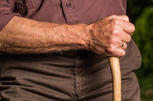 Man Holding Wood Cane