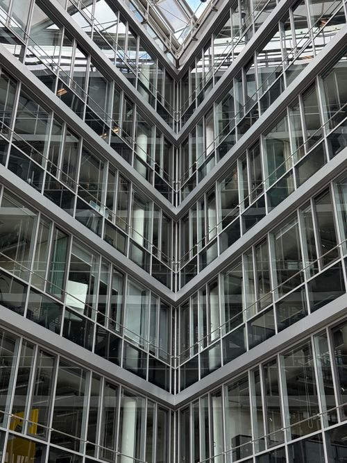Free A striking view of a modern glass building showcasing symmetry and architectural brilliance. Stock Photo
