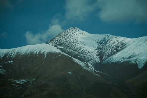 Free Stunning view of snow-capped mountains under a bright blue sky, showcasing nature's grandeur. Stock Photo