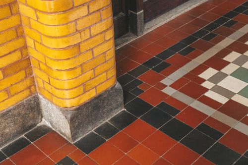 Free Tiled floor with yellow brick column in Semarang, Indonesia, showcasing intricate patterns. Stock Photo