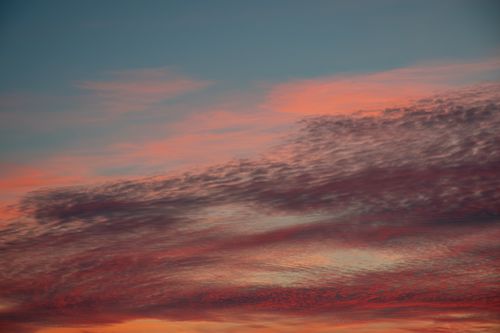 Free A beautiful sunset with vibrant, colorful clouds creating a dramatic sky. Stock Photo