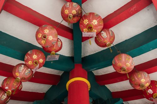 Free Vibrant red lanterns hanging from ornate temple ceiling in Jawa Tengah, Indonesia. Stock Photo
