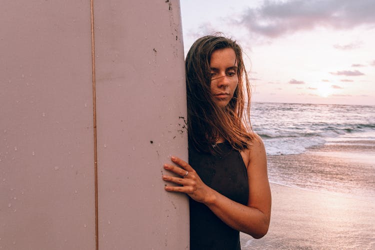 Woman Holding Surfboard At The Beach