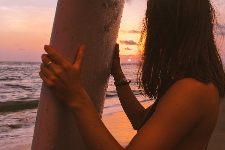 Close Up Photo Of Woman Holding Surfboard