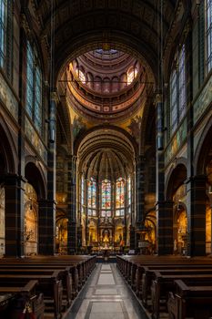 Intricate architectural details of the Basilica of Saint Nicholas in Amsterdam, showcasing stained glass windows and ornate design.