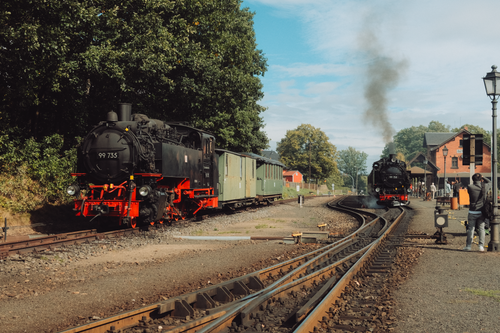 Free Historical steam trains captured at Jonsdorf station amidst Saxony's scenic backdrop. Stock Photo