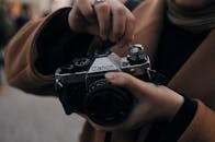 Photographer preparing old photo camera to take photo
