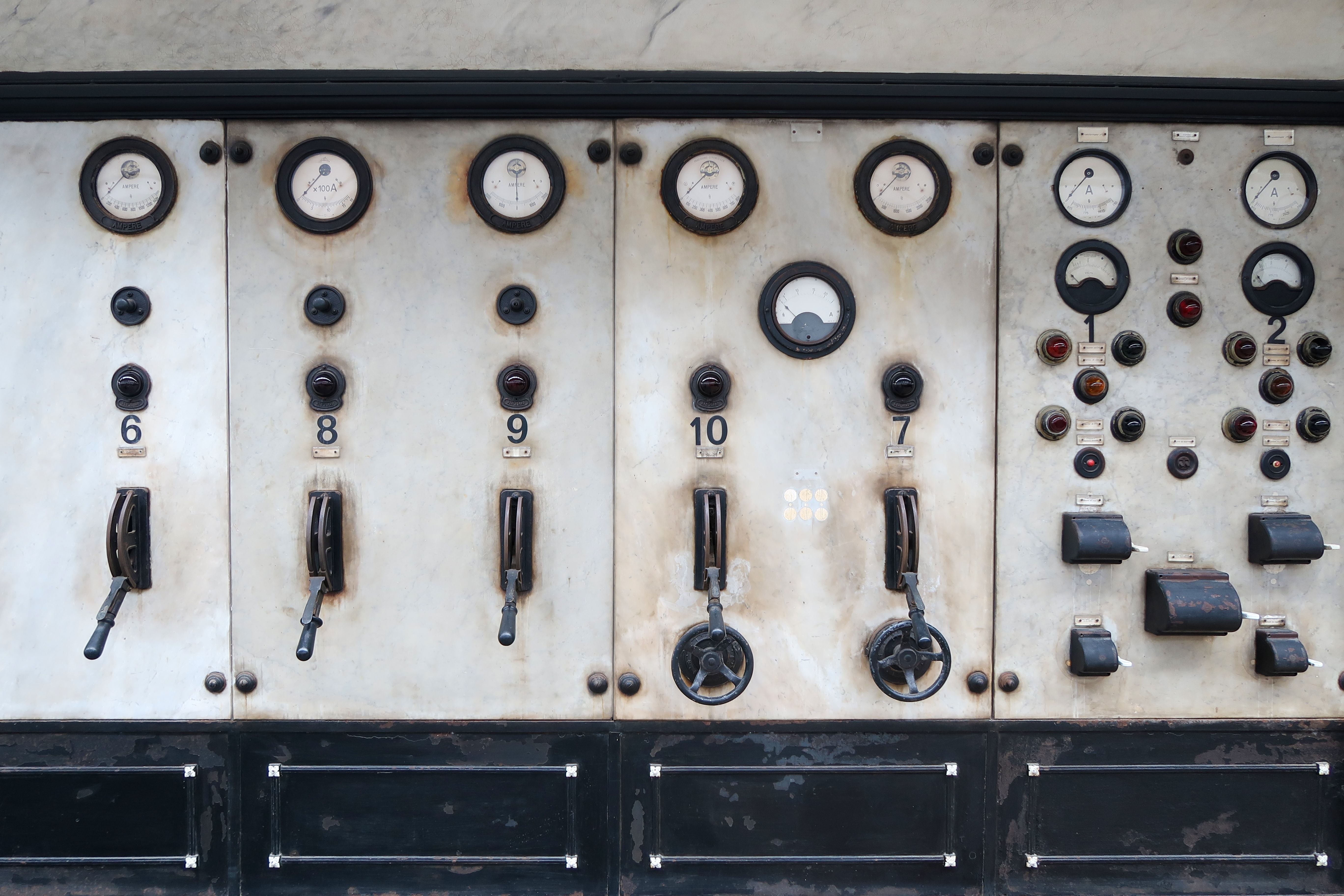 Vintage industrial control panel with gauges and levers.