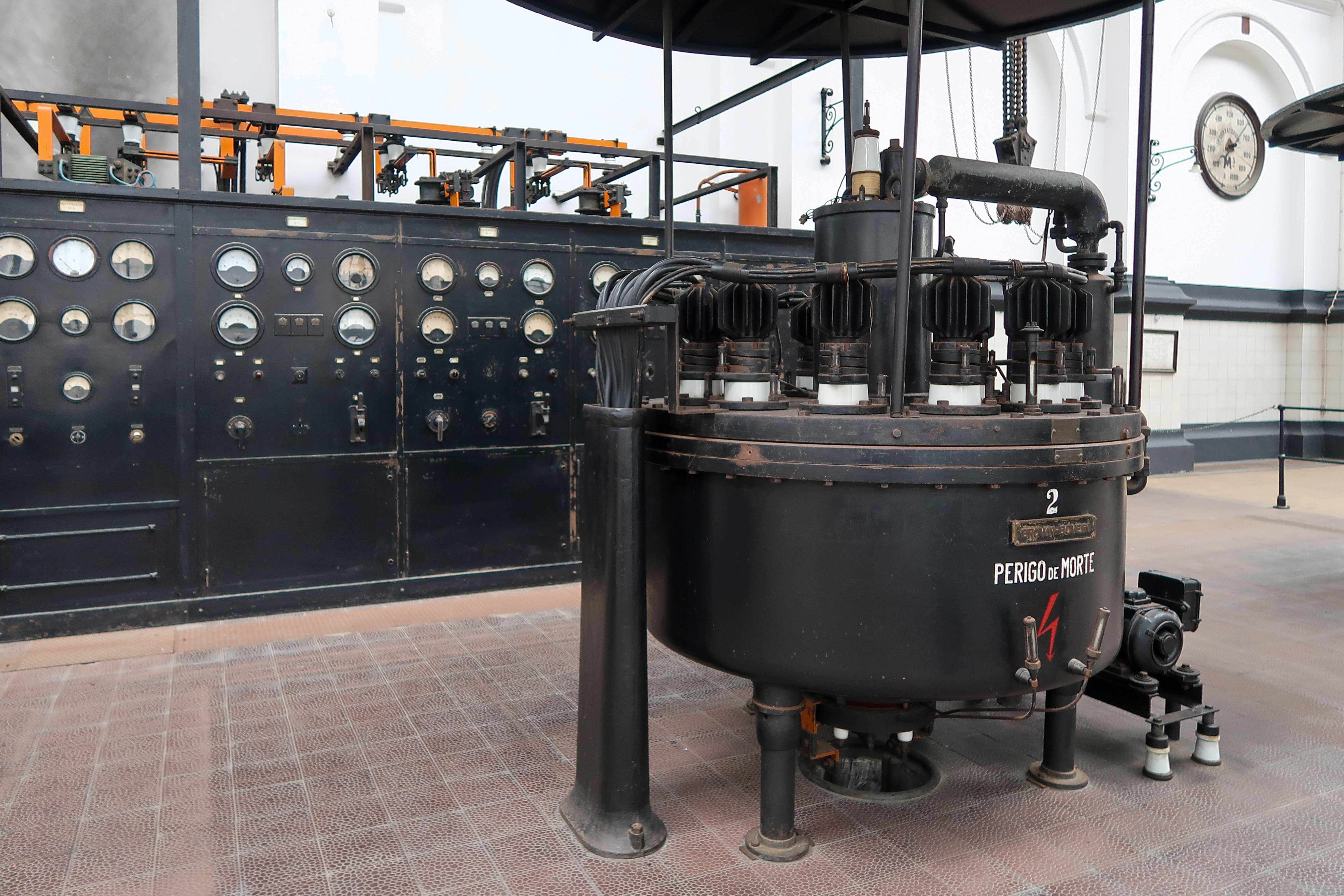 Historical industrial machinery and control panel inside a building.