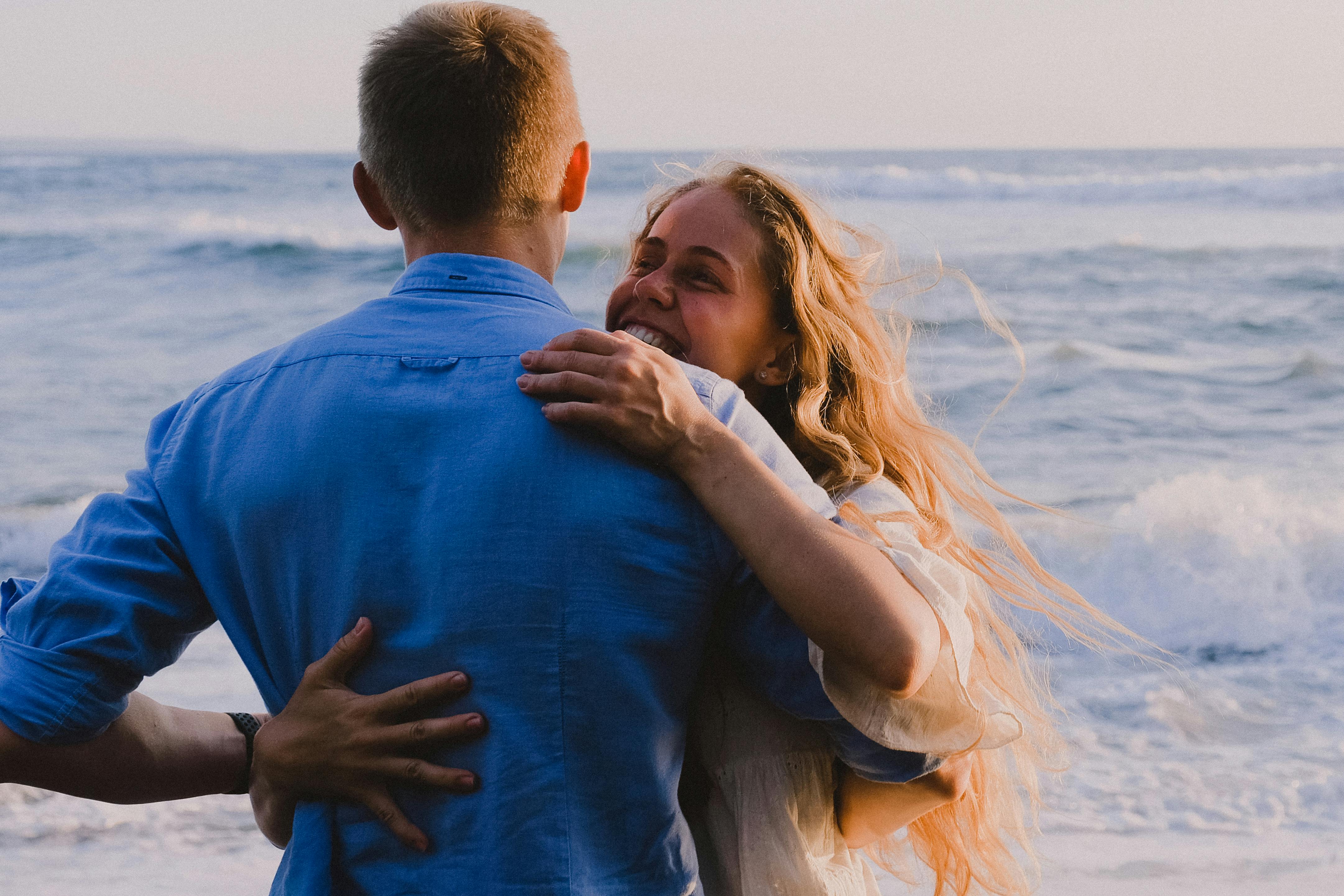 A Romantic Couple Hugging Each Other Near A Lake · Free Stock Photo