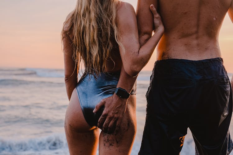 Back View Of A Couple On The Beach