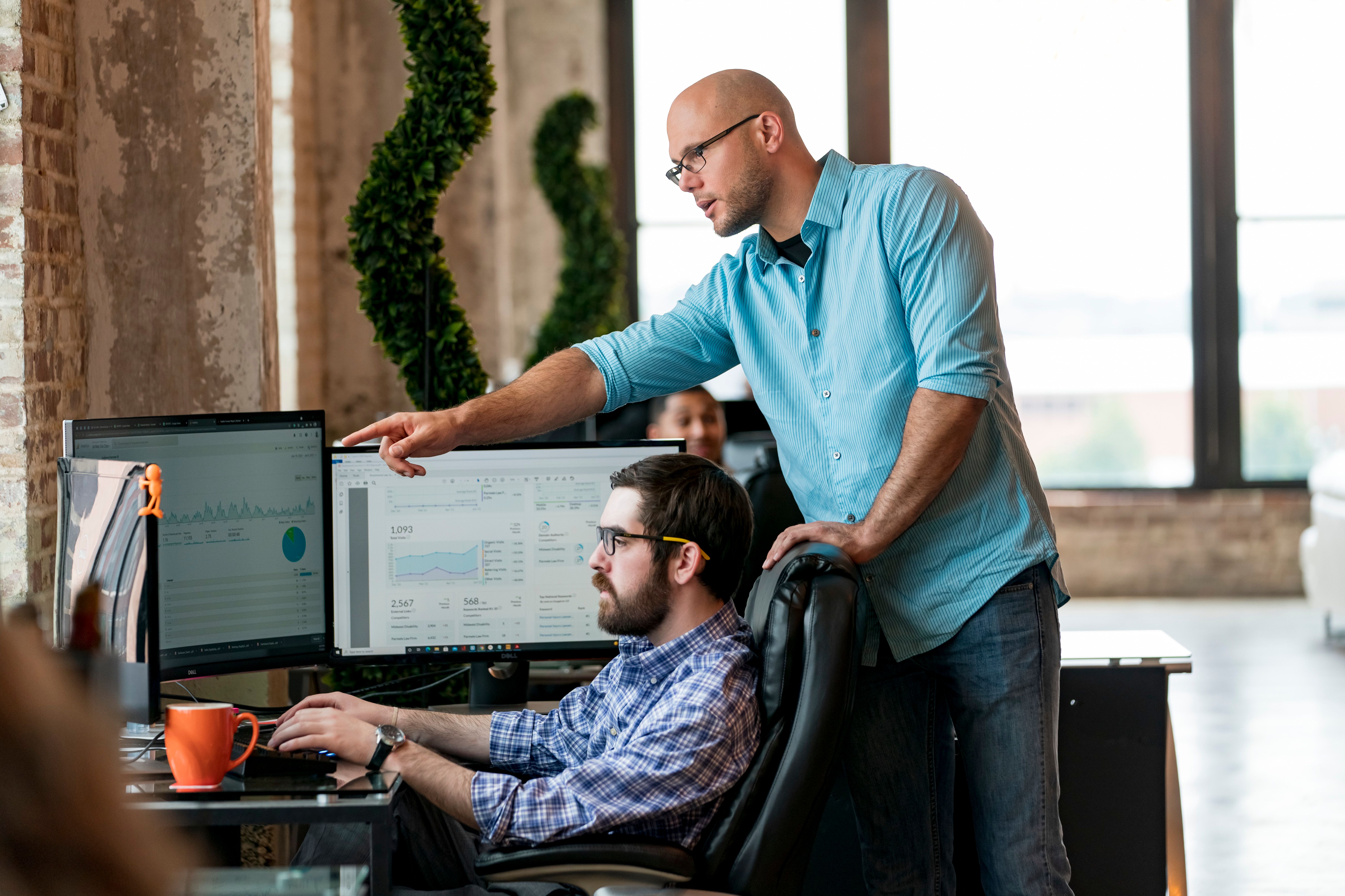 Team members collaborating on data analysis in a modern office in St. Louis.