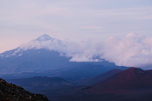A breathtaking view of Tolbachik Volcano amidst clouds in Kamchatka, Russia.