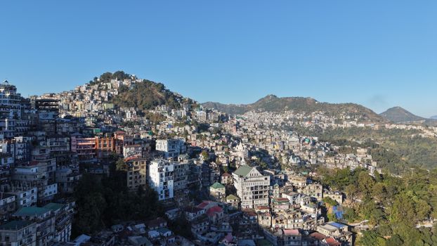 Aerial view of Aizawl city in Mizoram, India showcasing urban landscape amidst hills.