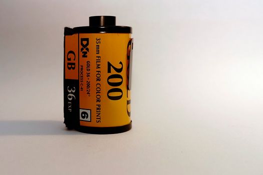 Film for old vintage cameras placed on white surface near bright light in studio