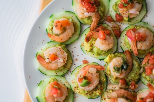 Delicious shrimp and guacamole on cucumber slices, perfect for a fresh seafood appetizer.