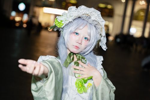 Free A detailed cosplay portrait with a floral hat and expressive pose captured during nighttime. Stock Photo