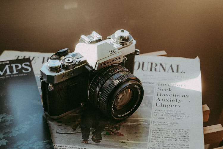 Vintage Fujica Camera On Top Of A Newspaper