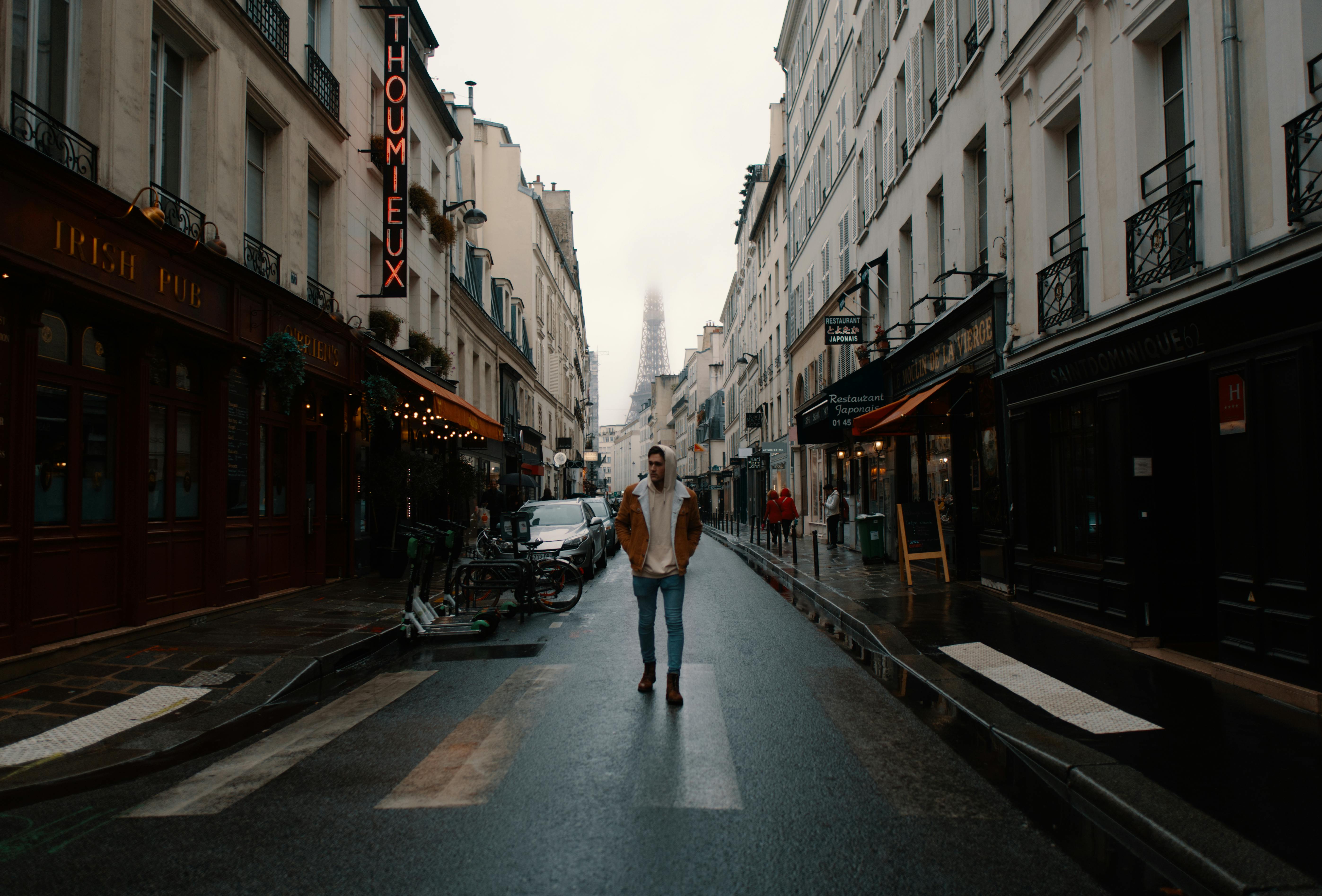 Tourist strolling along street in city center · Free Stock Photo