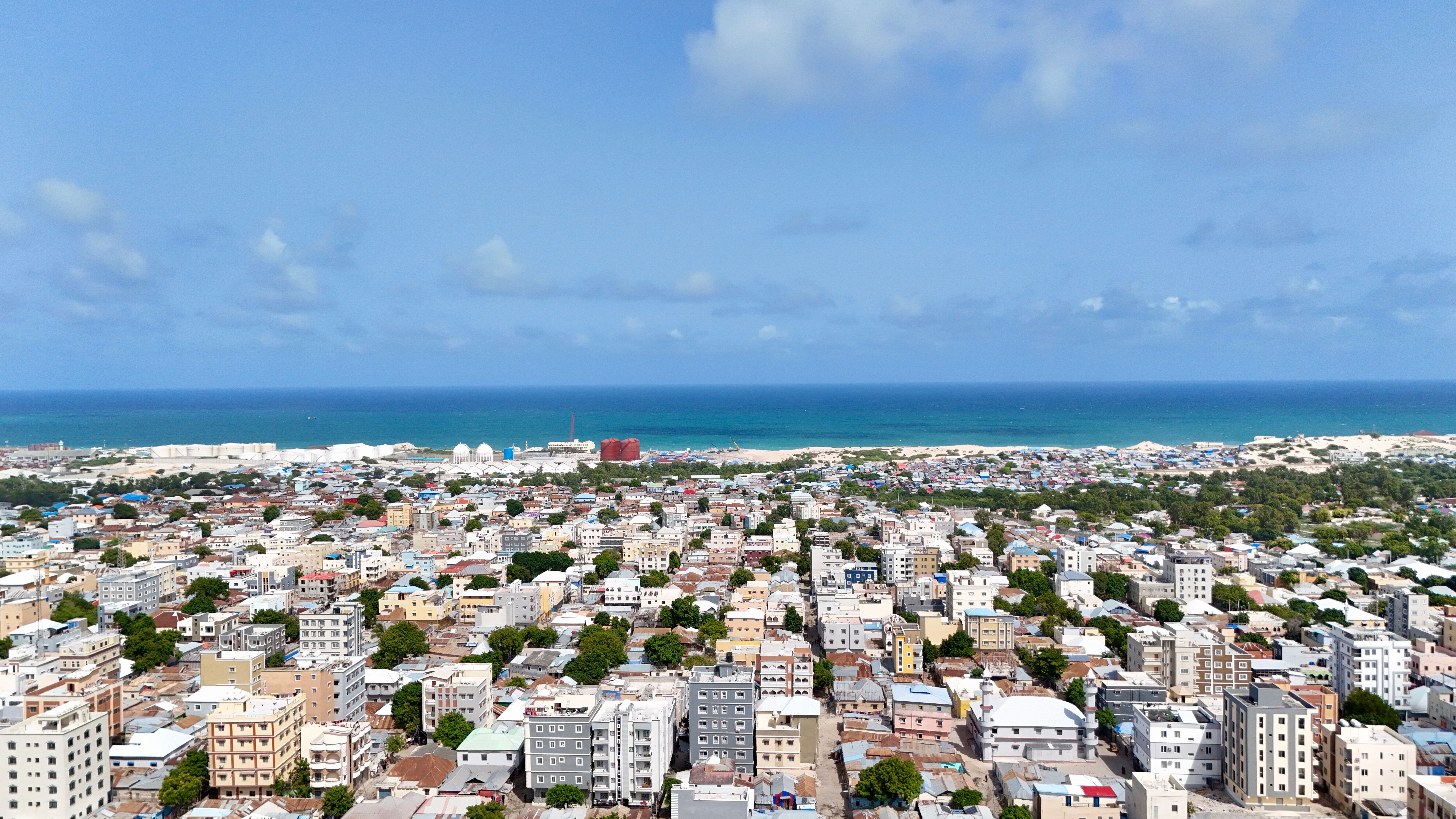 Explore the vibrant cityscape of Mogadishu with the serene backdrop of the Indian Ocean.