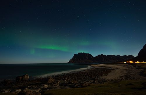 Free Stunning view of northern lights over the coastline in Nordland, Norway, at night. Stock Photo