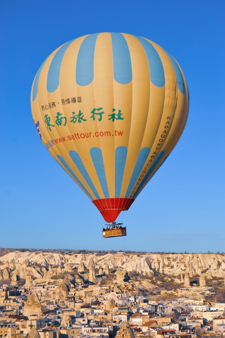 Hot Air Balloon Flying Over Town