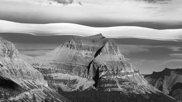 Stunning black and white photo of a rugged mountain in Montana with dramatic sky and clouds.