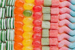 Set of delicious jelly and caramel sweets arranged in lines by type