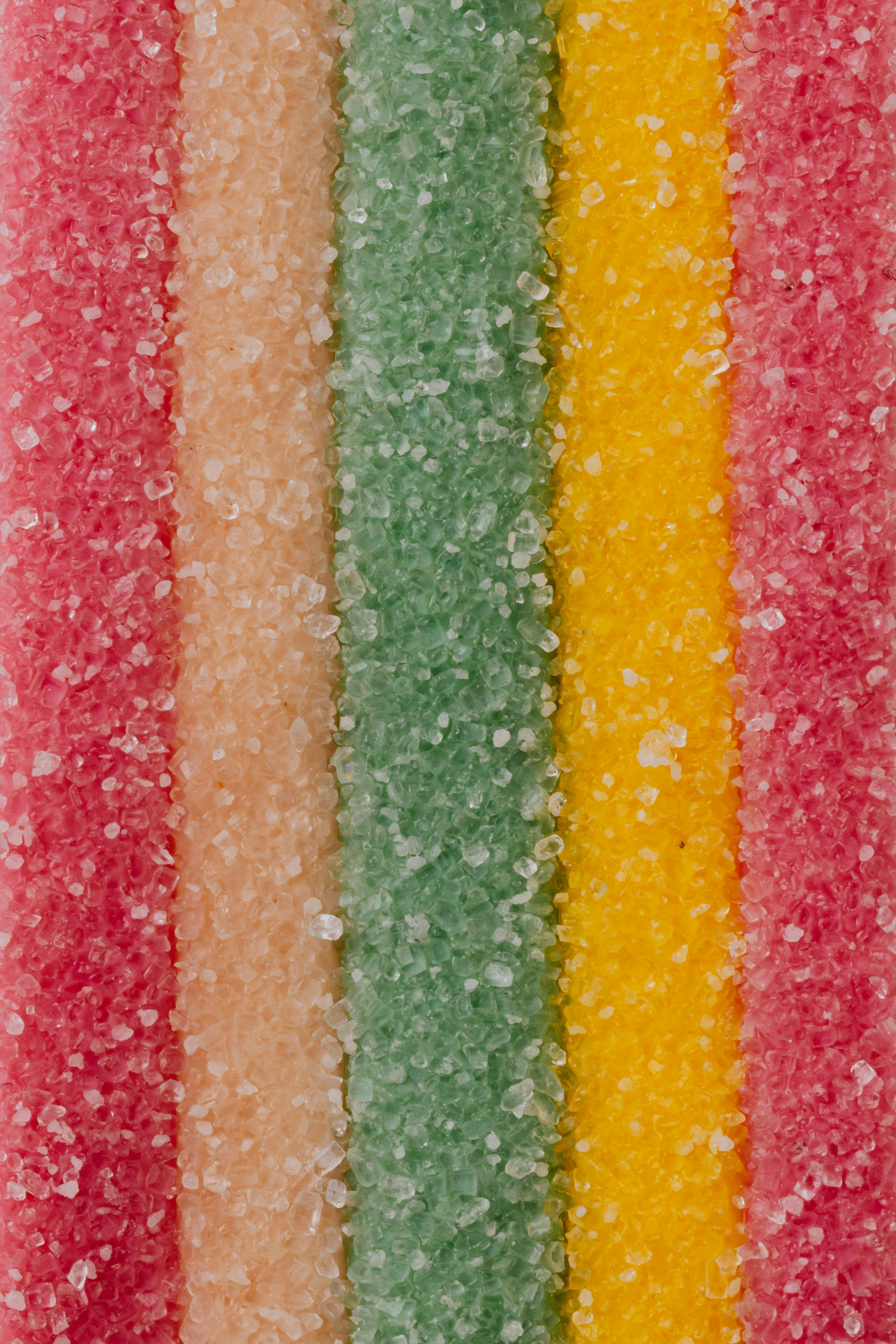 multicolored background of yummy sprinkled sweets placed in vertical lines