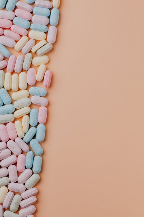 Heap of various sweets on pink background