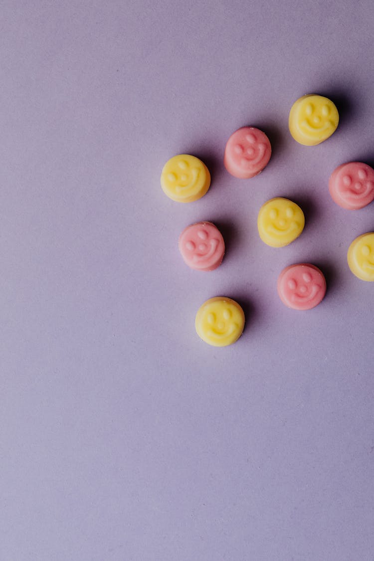 Top View Of Colorful Marshmallows On Purple Background