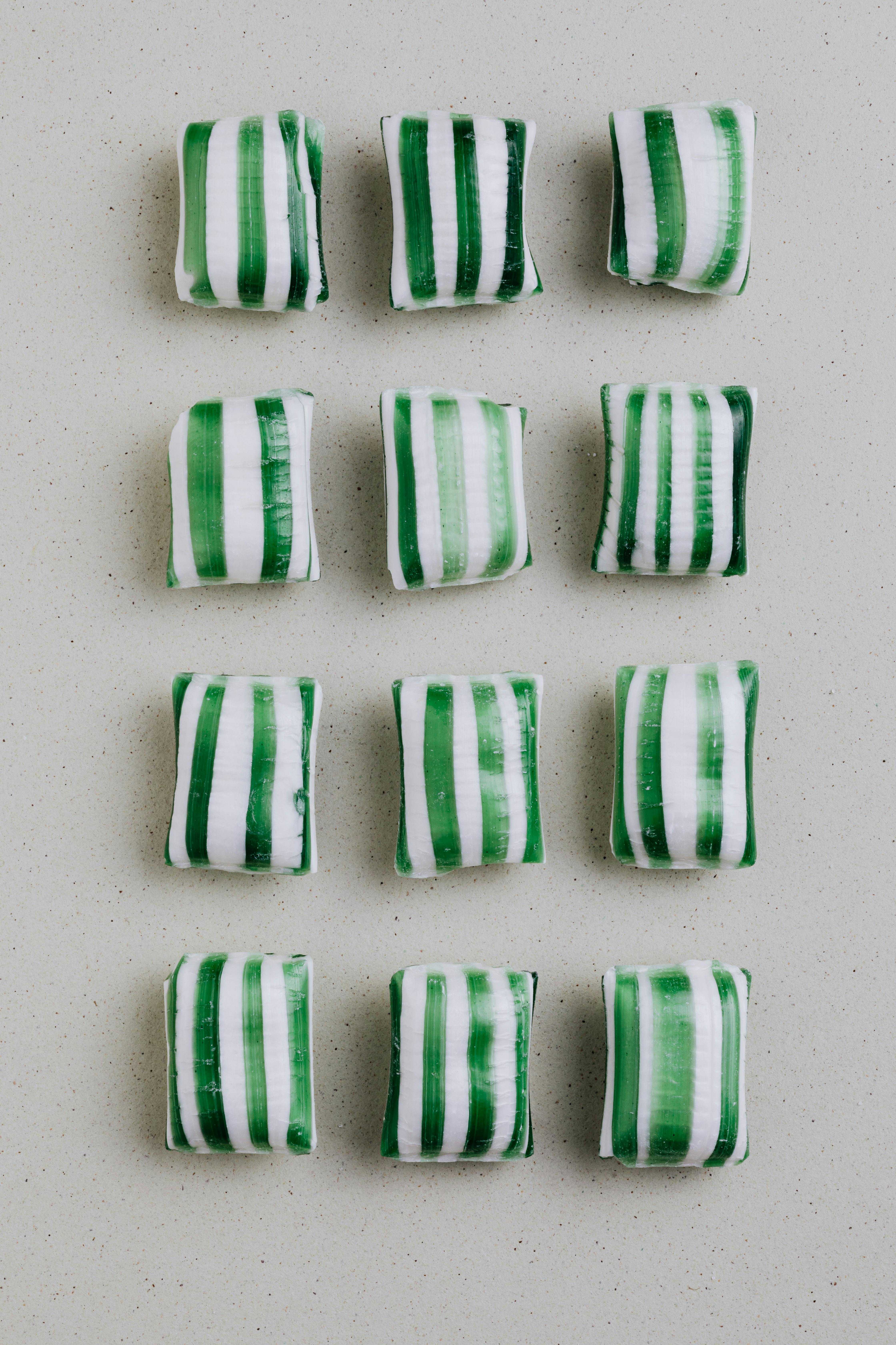 striped candies on gray background in rows