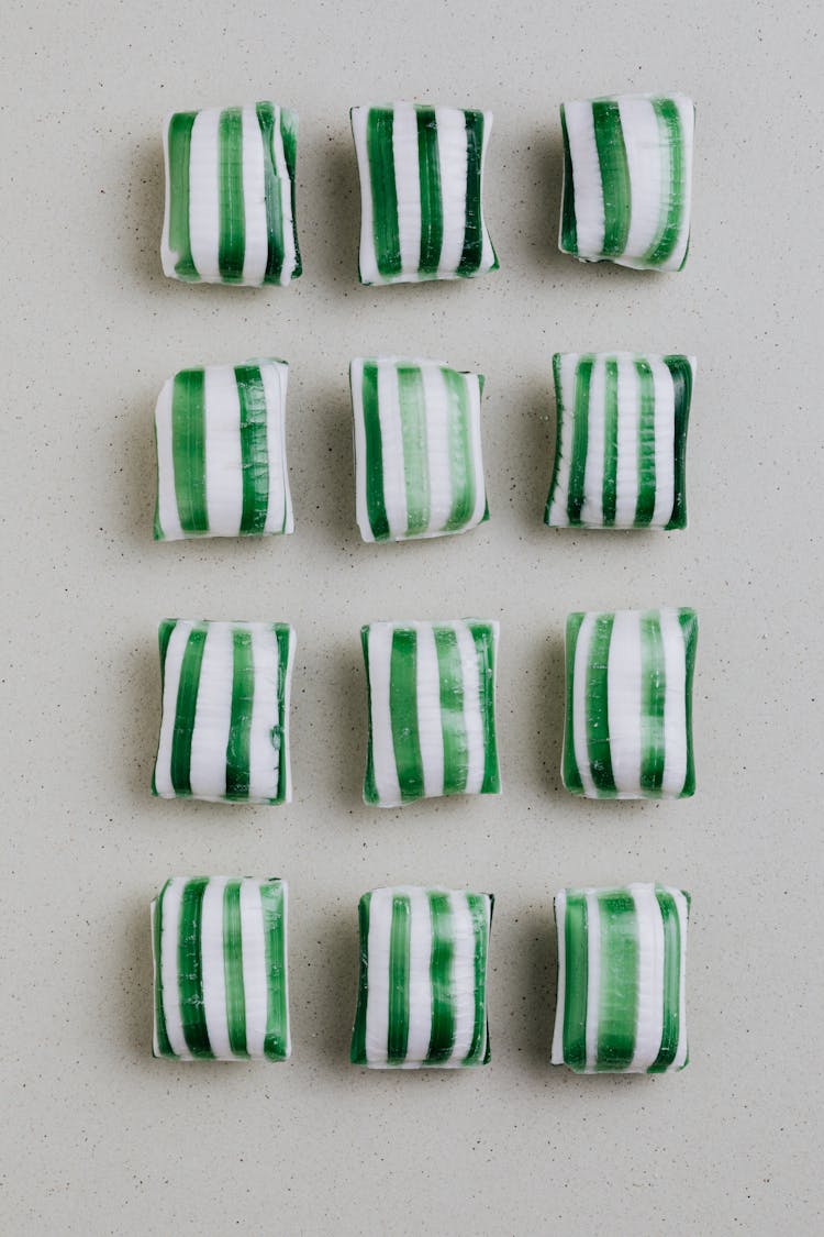 Striped Candies On Gray Background In Rows