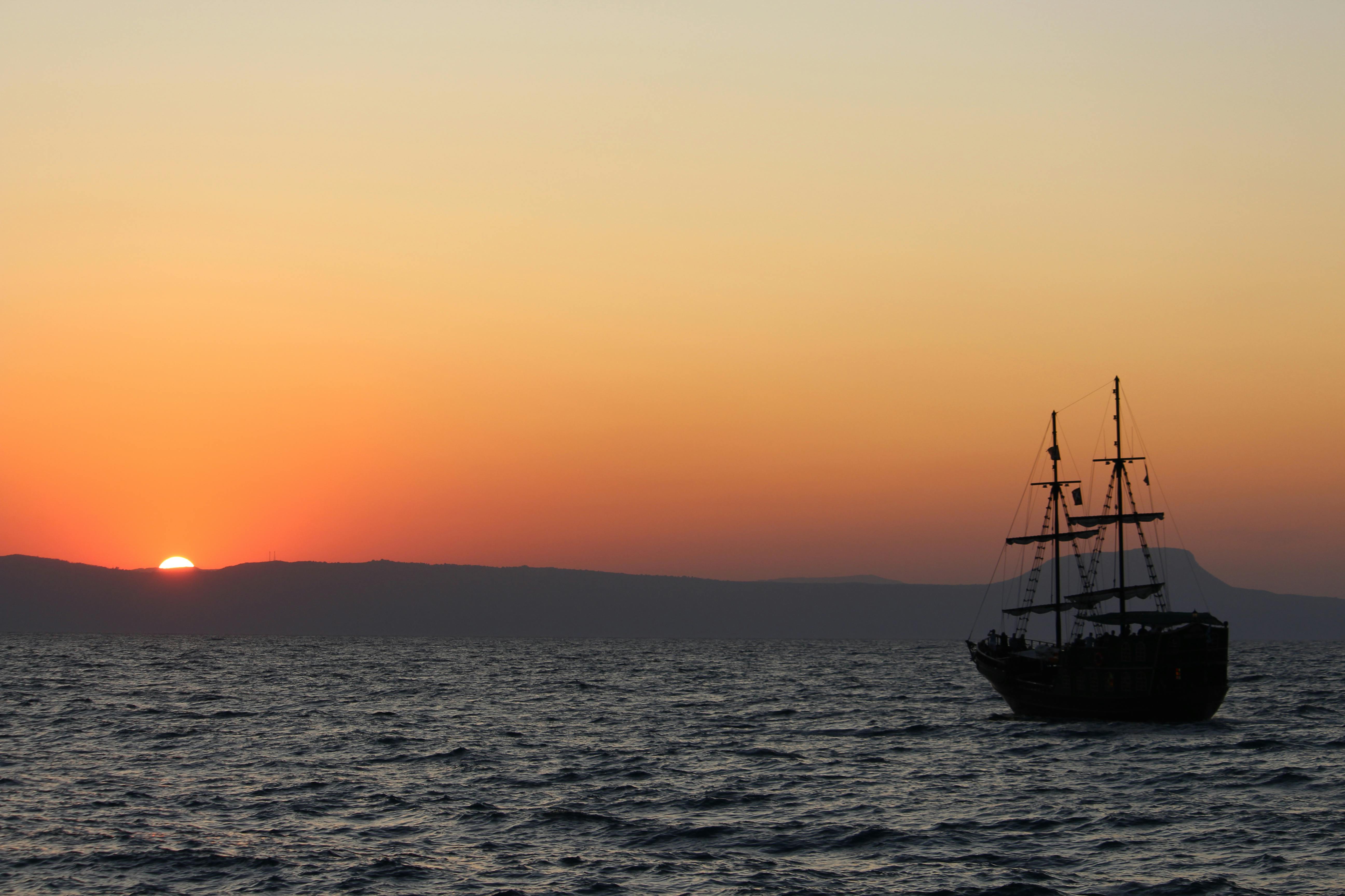 Silhouette of Boat on Sea during Sunset · Free Stock Photo