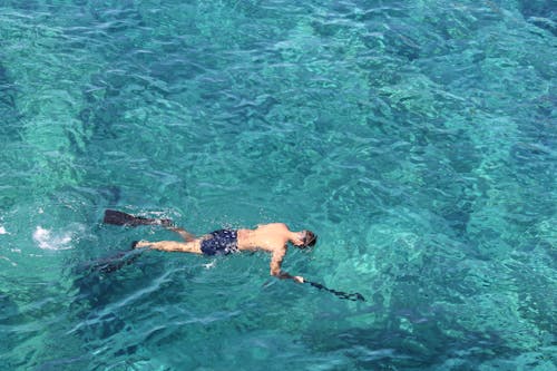 Man Snorkeling in Blue Ocean Water